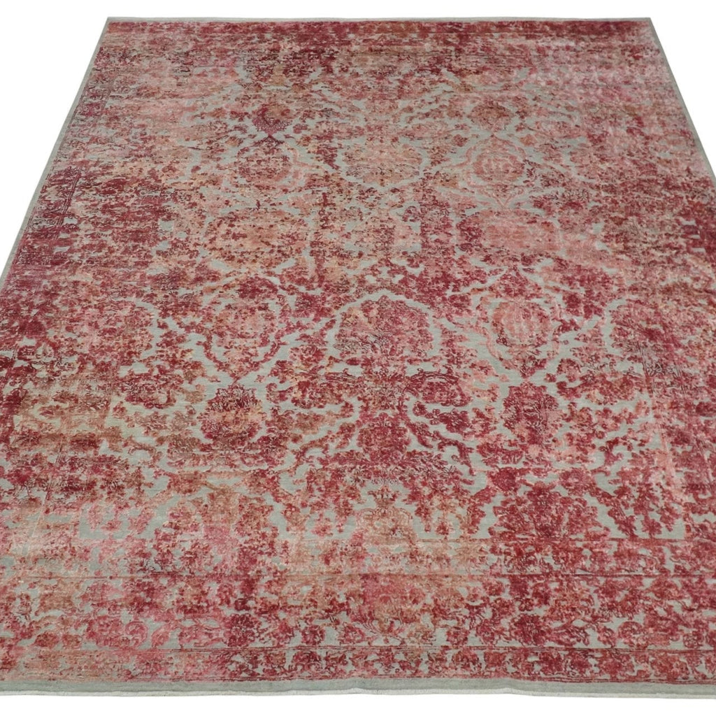 Red and beige patterned rug on a white background