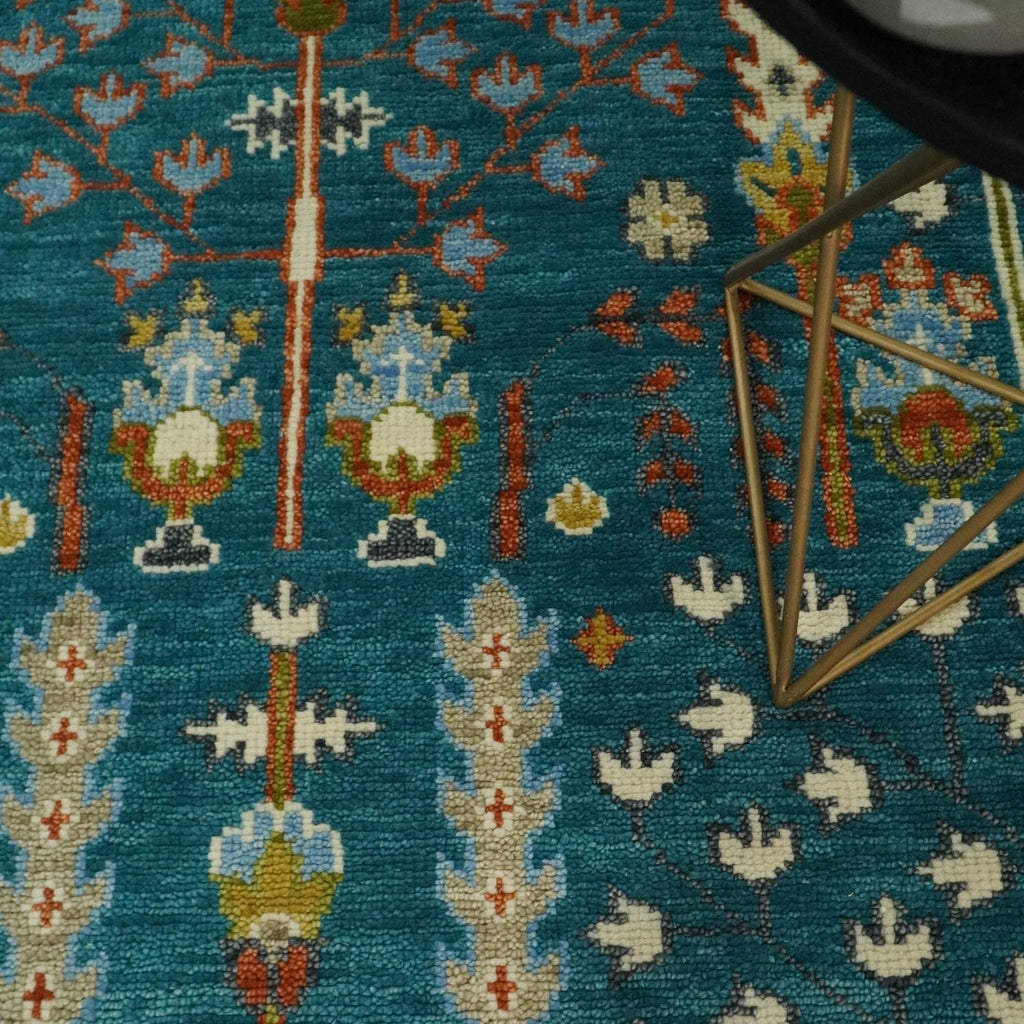 Close-up of a patterned rug with geometric designs on a blue background