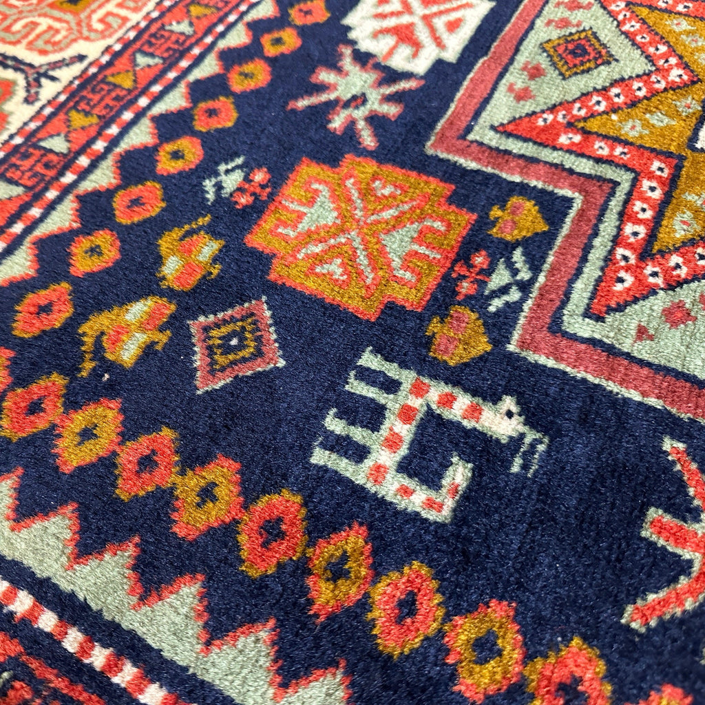 Close-up of a patterned rug with vibrant colors and intricate designs.